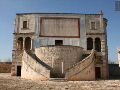 Dall�arco si snoda un viale lungo un centinaio di metri che porta ai piedi del prezioso edificio. La facciata principale in pietra chiara si presenta semplice e compatta: l'unica punta di colore � un riquadro rettangolare rosso che compare in alto e che probabilmente in origine ospitava un affresco